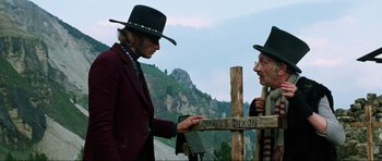 Movie still from “The Specialists” (1969), directed by Sergio Corbucci – A man in a cowboy hat is handing a sign to another man in a cowboy hat; Medium shot, Low angle