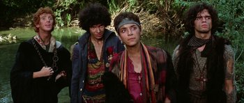 Movie still from “The Specialists” (1969), directed by Sergio Corbucci – Two young men standing next to each other near a body of water; Medium shot, Low angle