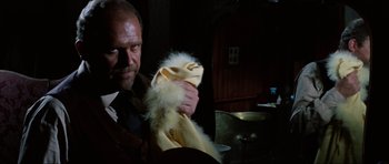 Movie still from “The Specialists” (1969), directed by Sergio Corbucci – A man holding a stuffed animal in his hands; Close Up shot, Low angle