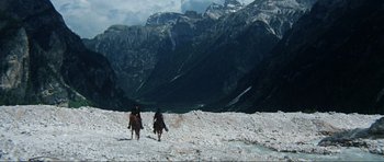 Movie still from “The Specialists” (1969), directed by Sergio Corbucci – Two people riding horses on a snow covered mountain; Extreme Wide shot, High angle