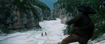 Movie still from “The Specialists” (1969), directed by Sergio Corbucci – Two people are riding horses through a canyon; Extreme Wide shot, High angle