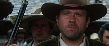 Movie still from “The Specialists” (1969), directed by Sergio Corbucci – A man with a cowboy hat on and another man wearing a cowboy hat; Close Up shot, Low angle