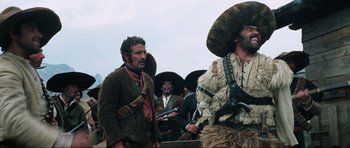 Movie still from “The Specialists” (1969), directed by Sergio Corbucci – A group of men standing next to each other holding guns; Medium shot, Low angle