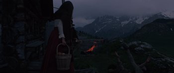Movie still from “The Specialists” (1969), directed by Sergio Corbucci – A woman holding a basket of apples in a field; Wide shot, High angle
