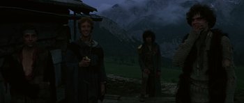 Movie still from “The Specialists” (1969), directed by Sergio Corbucci – Two men standing in front of a mountain at night; Wide shot, Low angle