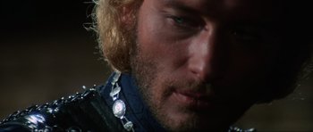Movie still from “The Specialists” (1969), directed by Sergio Corbucci – A person wearing a necklace; Close Up shot, Over the shoulder angle