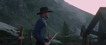 Movie still from “The Specialists” (1969), directed by Sergio Corbucci – A man in a cowboy hat holding a sheet of paper; Medium shot, Low angle