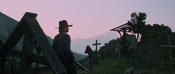Movie still from “The Specialists” (1969), directed by Sergio Corbucci – A man in a cowboy hat standing next to a cross; Wide shot, Low angle