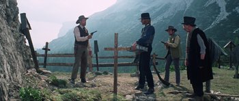 Movie still from “The Specialists” (1969), directed by Sergio Corbucci – A group of men standing on top of a hill; Wide shot, Low angle