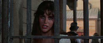 Movie still from “The Specialists” (1969), directed by Sergio Corbucci – A beautiful woman with blue eyes looking through a fence; Close Up shot, High angle