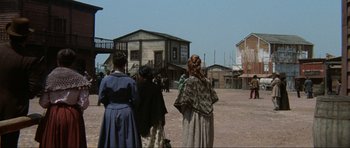 Movie still from “The Specialists” (1969), directed by Sergio Corbucci – A group of people standing on a dirt field; Wide shot, Low angle