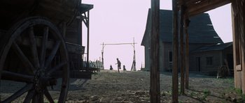 Movie still from “The Specialists” (1969), directed by Sergio Corbucci – A man is throwing a frisbee in a dirt field; Extreme Wide shot, Low angle
