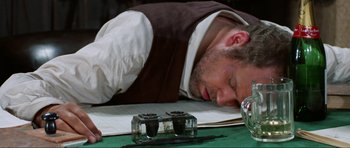 Movie still from “The Specialists” (1969), directed by Sergio Corbucci – A man sleeping on top of a table next to a pen and paper; Close Up shot, High angle