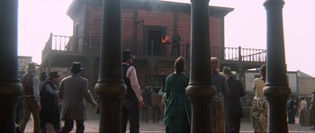 Movie still from “The Specialists” (1969), directed by Sergio Corbucci – A group of people standing in front of a building; Extreme Wide shot, Low angle