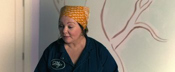 Movie still from “The Starling” (2021), directed by Theodore Melfi – A woman wearing a head scarf is looking down at her face; Close Up shot, Over the shoulder angle