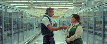 Movie still from “The Starling” (2021), directed by Theodore Melfi – A man and a woman are talking to each other in a store; Wide shot, Over the shoulder angle