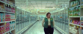 Movie still from “The Starling” (2021), directed by Theodore Melfi – A woman standing in front of refrigerators in a grocery store; Wide shot, Low angle