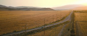 Movie still from “The Starling” (2021), directed by Theodore Melfi – An aerial view of an empty road in the middle of nowhere; Extreme Wide shot, High angle