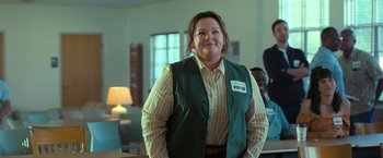 Movie still from “The Starling” (2021), directed by Theodore Melfi – A woman standing in a room wearing a vest; Medium shot, Over the shoulder angle