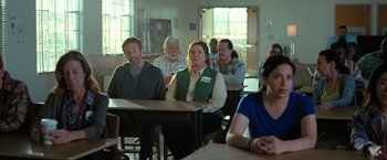 Movie still from “The Starling” (2021), directed by Theodore Melfi – A group of people sitting at a table in a room; Medium shot, Over the shoulder angle