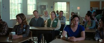 Movie still from “The Starling” (2021), directed by Theodore Melfi – A group of people sitting at tables in a room; Medium shot, Over the shoulder angle