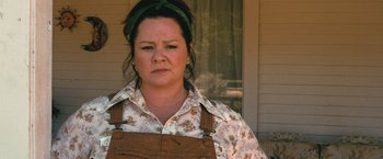 Movie still from “The Starling” (2021), directed by Theodore Melfi – A woman in overalls standing in front of a building; Close Up shot, Low angle