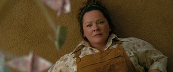 Movie still from “The Starling” (2021), directed by Theodore Melfi – A woman with a flower in her hair and wearing overalls; Close Up shot, Overhead angle