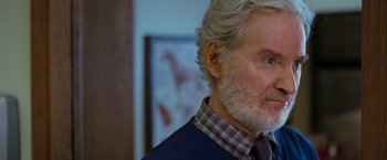 Movie still from “The Starling” (2021), directed by Theodore Melfi – An older man with a gray beard wearing a blue jacket; Close Up shot, Over the shoulder angle