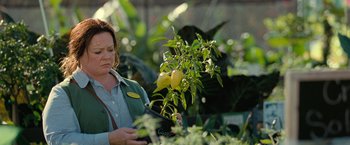 Movie still from “The Starling” (2021), directed by Theodore Melfi – A woman is looking at a lemon tree in a greenhouse; Close Up shot, Over the shoulder angle