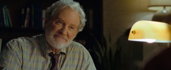Movie still from “The Starling” (2021), directed by Theodore Melfi – An older man wearing a plaid shirt and a tie; Close Up shot, Over the shoulder angle