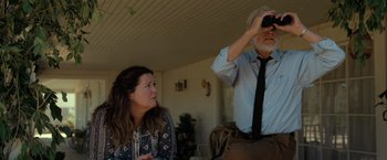 Movie still from “The Starling” (2021), directed by Theodore Melfi – An older man and a younger woman looking at something in the distance; Medium shot, Low angle