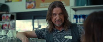 Movie still from “The Starling” (2021), directed by Theodore Melfi – A man with long brown hair and a beard; Close Up shot, Over the shoulder angle