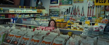Movie still from “The Starling” (2021), directed by Theodore Melfi – A woman in a grocery store holding boxes of food; Wide shot, High angle