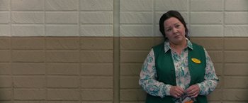 Movie still from “The Starling” (2021), directed by Theodore Melfi – A woman leaning against a brick wall with her arms crossed; Medium shot, High angle