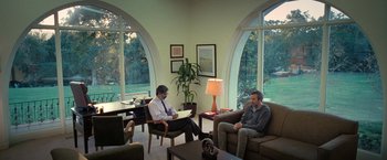 Movie still from “The Starling” (2021), directed by Theodore Melfi – Two men are sitting in a living room; Wide shot, Over the shoulder angle