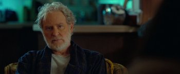Movie still from “The Starling” (2021), directed by Theodore Melfi – An older man sitting in a chair in front of a window; Close Up shot, Over the shoulder angle