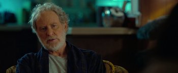 Movie still from “The Starling” (2021), directed by Theodore Melfi – An older man sitting on a chair in front of a window; Close Up shot, Over the shoulder angle