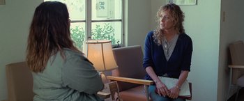 Movie still from “The Starling” (2021), directed by Theodore Melfi – A woman sitting on a couch talking to another woman; Medium shot, Over the shoulder angle