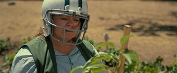 Movie still from “The Starling” (2021), directed by Theodore Melfi – A woman wearing a football helmet while standing in a field; Close Up shot, Low angle