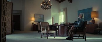Movie still from “The Starling” (2021), directed by Theodore Melfi – A dining room with a table and chairs and a chandelier; Wide shot, High angle