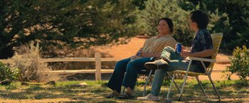 Movie still from “The Starling” (2021), directed by Theodore Melfi – A woman sitting on a chair next to a man; Wide shot, High angle