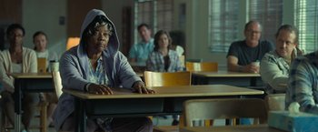 Movie still from “The Starling” (2021), directed by Theodore Melfi – An older woman sitting at a table in front of two other people; Medium shot, Over the shoulder angle