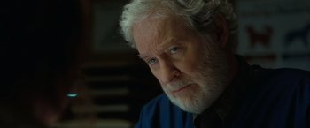 Movie still from “The Starling” (2021), directed by Theodore Melfi – An older man with white hair and blue eyes looking at the camera; Close Up shot, Over the shoulder angle