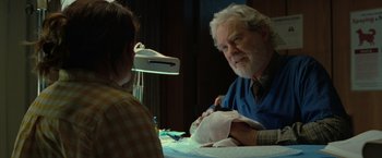 Movie still from “The Starling” (2021), directed by Theodore Melfi – An older man with white hair and a white beard is sitting down with a young woman; Close Up shot, Over the shoulder angle