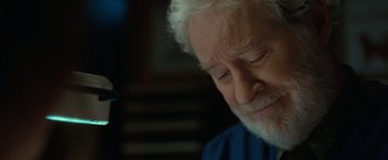 Movie still from “The Starling” (2021), directed by Theodore Melfi – An older man with white hair is looking down; Close Up shot, Over the shoulder angle