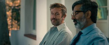 Movie still from “The Starling” (2021), directed by Theodore Melfi – A man with a goatee is sitting next to another man; Close Up shot, Over the shoulder angle