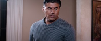 Movie still from “The Starter Marriage” (2021), directed by Arthur Muhammad – A person wearing a gray sweater; Close Up shot, Over the shoulder angle