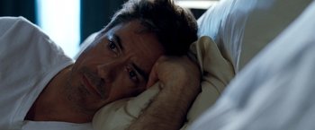 Movie still from “Due Date” (2010), directed by Todd Phillips – A person laying in bed; Close Up shot, High angle