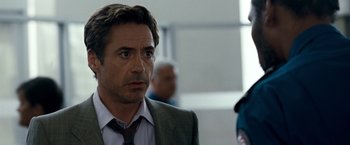 Movie still from “Due Date” (2010), directed by Todd Phillips – A person wearing a suit and tie; Close Up shot, Over the shoulder angle