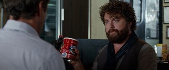Movie still from “Due Date” (2010), directed by Todd Phillips – A man holding a cup of coffee in his hand; Close Up shot, Over the shoulder angle